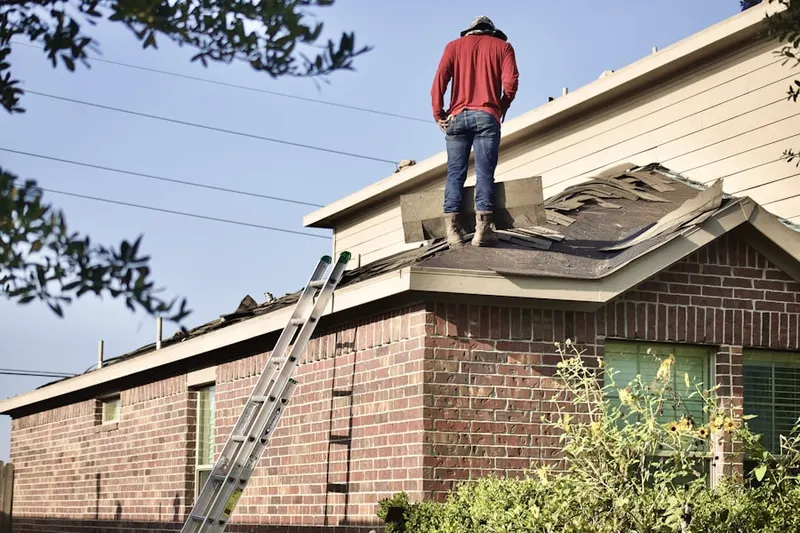 Professional roofer working on a residential roof in Rio Paseo